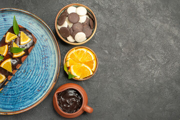 Delicious cake decorated with lemon and chocolate with other cookies on dark background footage