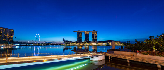 Beautiful Singapore night view before sunrise with Merlion and Marina Bay Sands Hotel