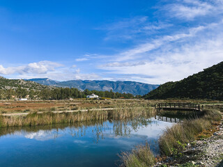 Beautiful peaceful valley with the river, reflection of the mountains on the surface of the water