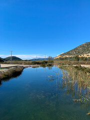 Obraz premium Beautiful peaceful valley with the river, reflection of the mountains on the surface of the water