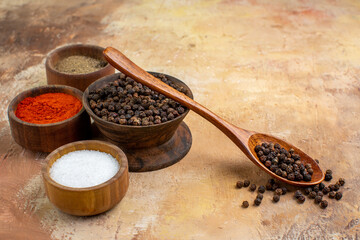 front view different seasonings inside little pots on the wooden desk salt pepper color food