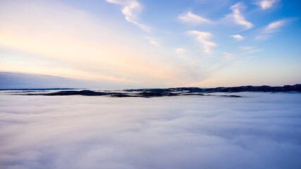 Arial: Photo shot with a drone. Fog in the valley below.  Norway, Oslo, Holmenkollen.