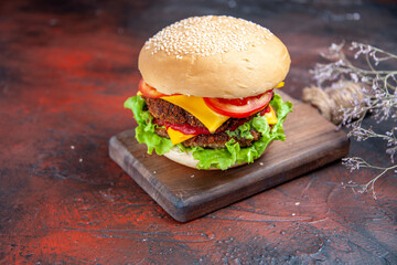 front view meat burger with cheese salad and tomatoes on a dark background meal bun sandwich