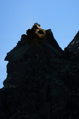 mountain peak at sunset with climber