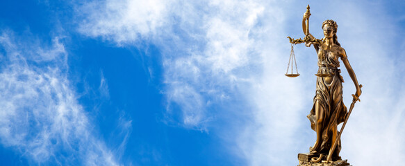 Statue of justice. Close-up Of Justice Lady Against blue sky panoramic Background. 