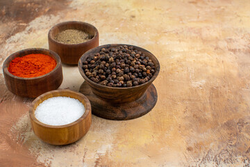 front view different seasonings inside little pots on a wooden desk salt pepper color food