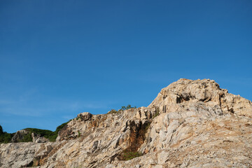 Fototapeta na wymiar Natural landscape, Rock hill against the blue sky at Khoa Kuha, Songkhla, South of Thailand.