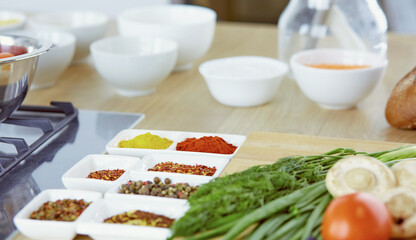 Composition with wooden board and ingredients for cooking on table