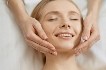 Naklejka premium Beautiful young woman in cosmetic salon close up