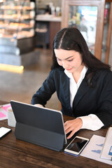 Businessman using computer tablet browsing financial website for checking banking exchange.