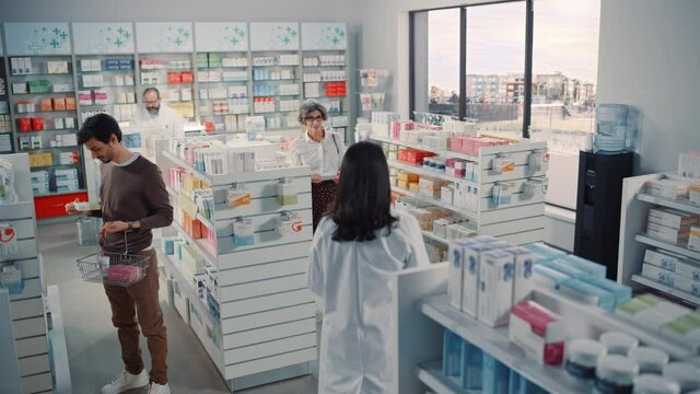 Pharmacy Drugstore: Diverse Group of Latin Customers Searching to Buy Prescription Medicine, Drugs, Vitamins, Professional Pharmacist Help Client with Advice