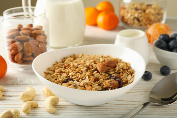 Concept of tasty breakfast with granola on wooden background
