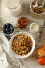 Concept of tasty breakfast with granola on wooden background