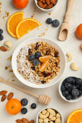 Concept of tasty breakfast with granola on white background