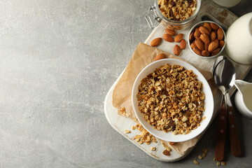 Concept of tasty breakfast with granola on gray background