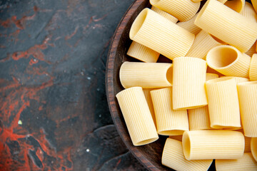 Half shot of uncooked pastas inside the pot on black background footage