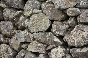 Closeup of a dry stone wall with lichen