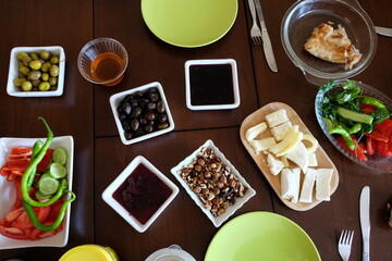 Traditional Turkish breakfast table. It is including honey, butter, different types of cheese and walnuts, olives, jams, slices of tomatoes, cucumbers, green peppers. Healthy food concept. Dieting.