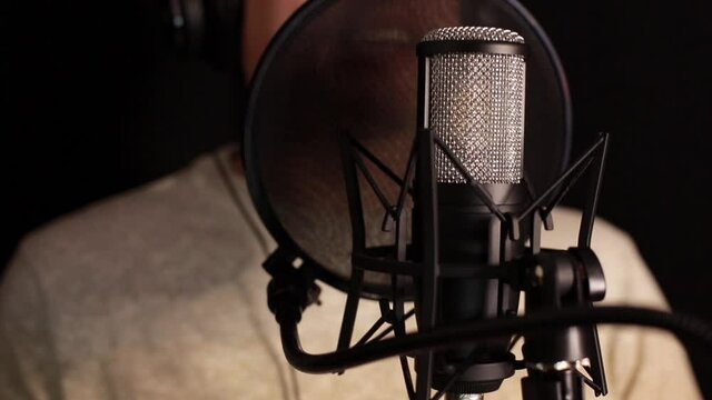 A professional announcer makes a recording in the studio