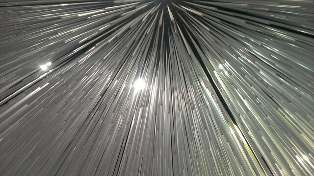 Beautiful white slim stalactites in perspective with lights, abstract rays texture for background