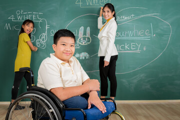 Portrait of disabled student kids in element school with woman teacher and normal student use chalk to drawing and writing creative art on chalkboard together