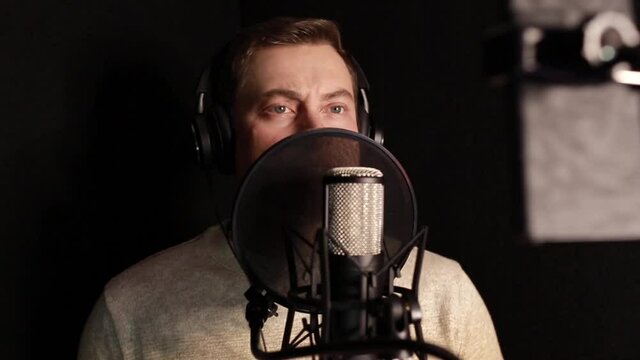 A professional announcer makes a recording in the studio