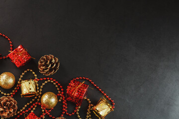 Christmas or New Years dark background with red and gold decorations for the Christmas tree with free space.