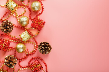 Christmas composition of decorations and Christmas toys on a pink background