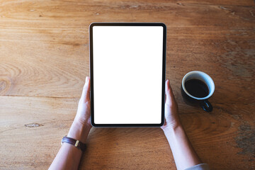 Top view mockup image of a woman holding digital tablet with blank white desktop screen