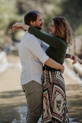 Engagement photo session of a young couple in the countryside. Caucasian couple, with a modern style.  Family enjoying tender moment, happy marriage. family concept.