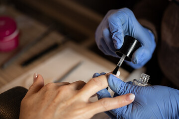 Closeup shot of a woman in a nail salon receiving a manicure - obrazy, fototapety, plakaty