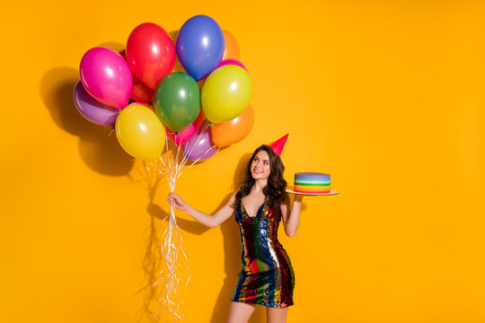Photo of positive cheerful girl prepare festive occasion party hold birthday cake look balloons wear glossy skirt isolated over bright shine color background