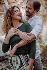 Engagement photo session of a young couple in the countryside. Caucasian couple, with a modern style. Family enjoying tender moment, happy marriage. family concept