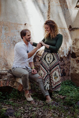 Engagement photo session of a young couple in the countryside. Caucasian couple, with a modern style. Family enjoying tender moment, happy marriage. family concept
