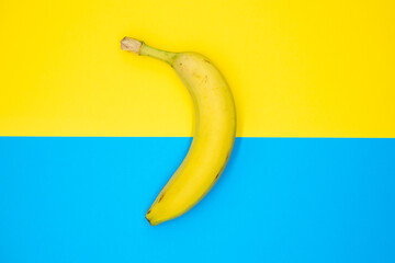 Yellow banana on color background abstract food photo