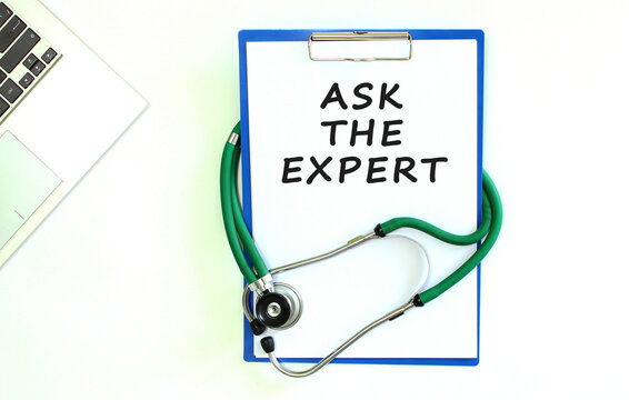 Stethoscope and clipboard with ASK THE EXPERT text on white sheet of paper.