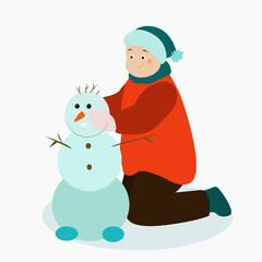 A boy makes a snowman out of snow