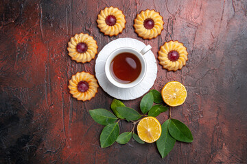 top view cup of tea with little cookies on dark background biscuit sweet dessert