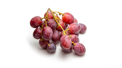 Close up a bunch of fresh red grapes on isolated white background.