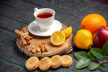 front view cup of tea with fruits and cookies on dark floor photo ceremony sweet
