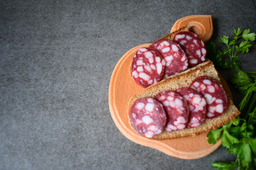 Black bread sandwich and salami sausage with place for text