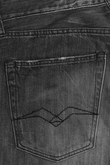 The texture of the denim is black. The background of jeans