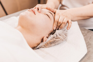 Obraz na płótnie Canvas Facial massage is an exercise for the face, as a result, the skin becomes smooth, healthy, elastic - massage helps fight wrinkles.