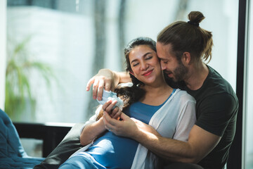 Happy pregnant couple waiting for baby at home, Pregnant couple of husband and wife