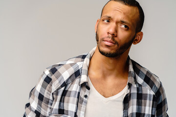 Handsome stylish young african american man wearing shirt - looking disturbed or confused