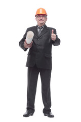 An architect wearing a hard hat and holding plans