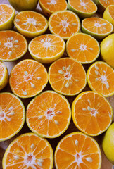 Orange fruit with cut in half on wooden background