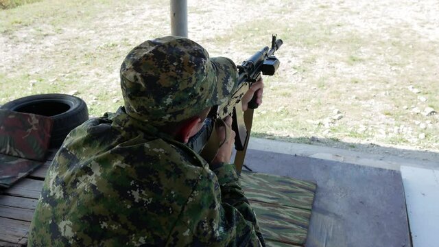 Man terrorist shoots machine gun at enemies targets. police officer in the war conflict russian military army training shooting FSB police kill criminals