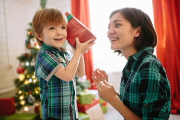 Happy family mom and son on a Christmas - 399950464