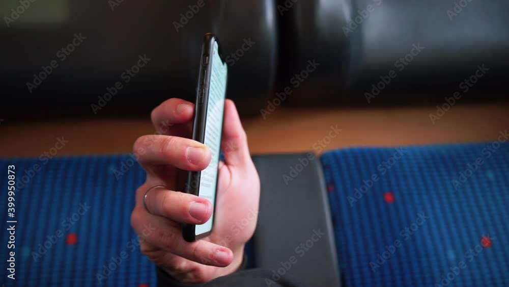 Poster using the mobile application. reading an e-book. the man uses a mobile phone. hand holds a smartphon